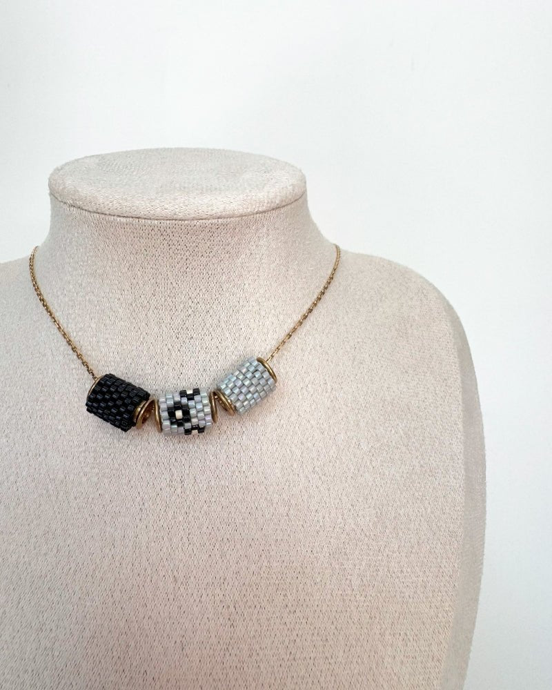 Necklace with three beaded charms crafted in peyote stitch technique using Japanese Miyuki Delica beads in neutral grey and black color palette - Fleur Du Jour