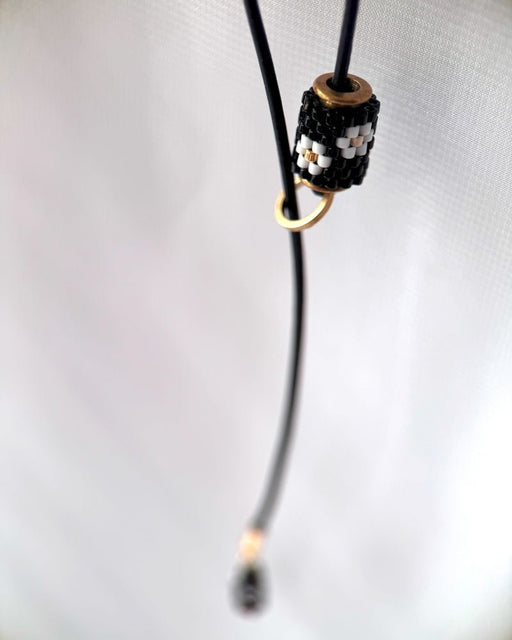 Minimalist black lariat necklace with adjustable length, featuring floral beaded pendant and matching charm - Fleur Du Jour