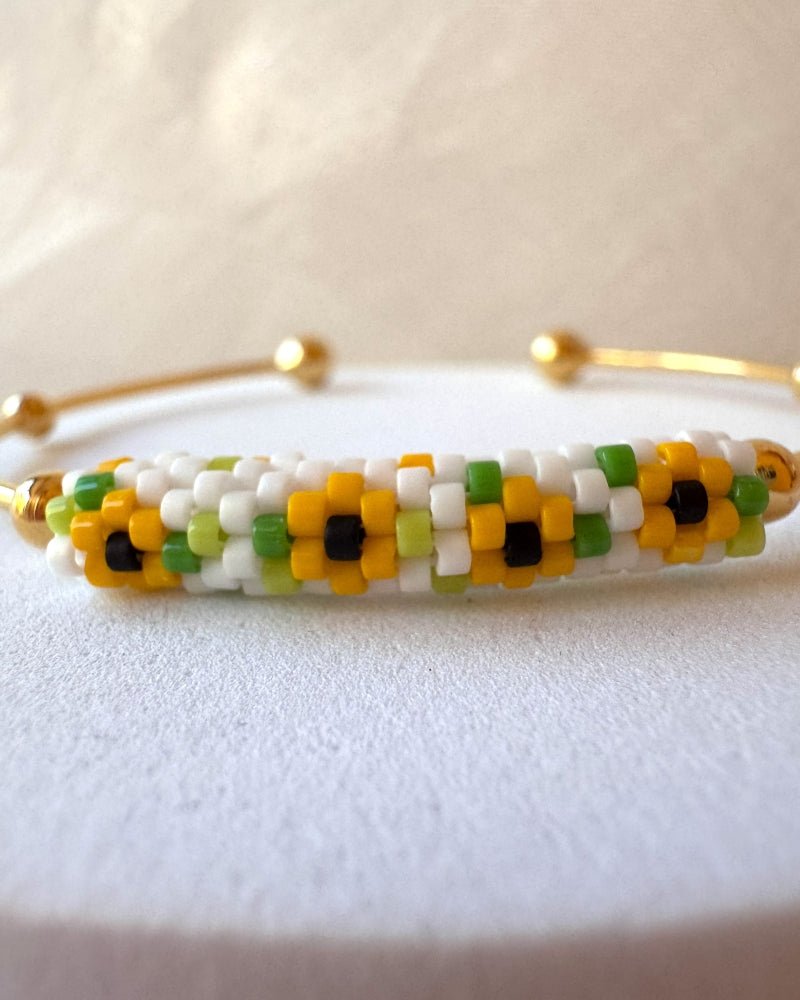 Delicate sunflower bracelet with Miyuki Delica beadwork and an open gold-plated bangle setting with ball details – Fleur du Jour