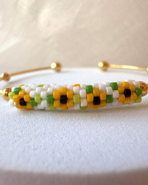 Delicate sunflower bracelet with Miyuki Delica beadwork and an open gold-plated bangle setting with ball details – Fleur du Jour