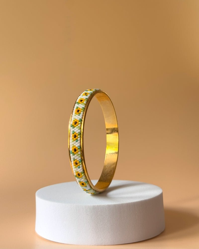 Gold-plated bangle bracelet with beaded inlay crafted in peyote stitch technique from Japanese Miyuki beads in a color palette inspired by sunflowers - Fleur Du Jour