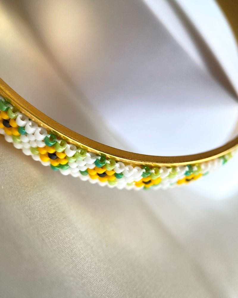 Gold-plated bangle bracelet with beaded inlay crafted in peyote stitch technique from Japanese Miyuki beads in a color palette inspired by sunflowers - Fleur Du Jour