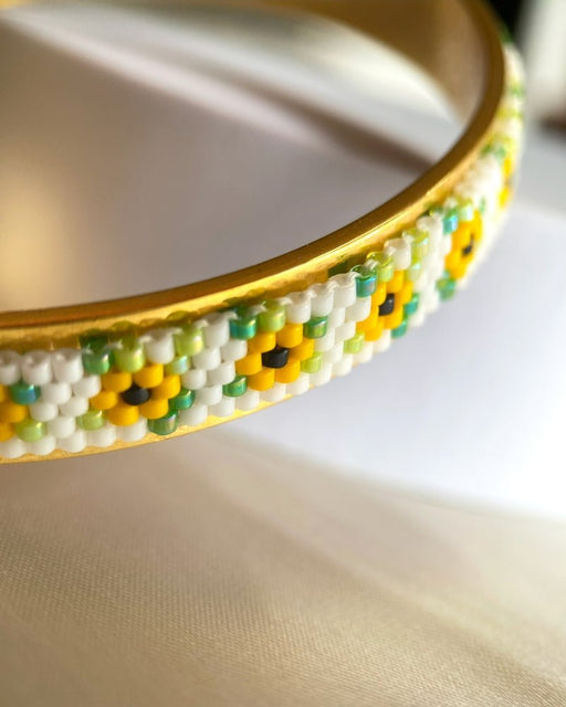 Gold-plated bangle bracelet with beaded inlay crafted in peyote stitch technique from Japanese Miyuki beads in a color palette inspired by sunflowers - Fleur Du Jour