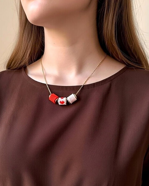 Necklace with three beaded charms crafted in peyote stitch technique using Japanese Miyuki Delica beads in scaret red and pale pink palette with heart motif - Fleur Du Jour