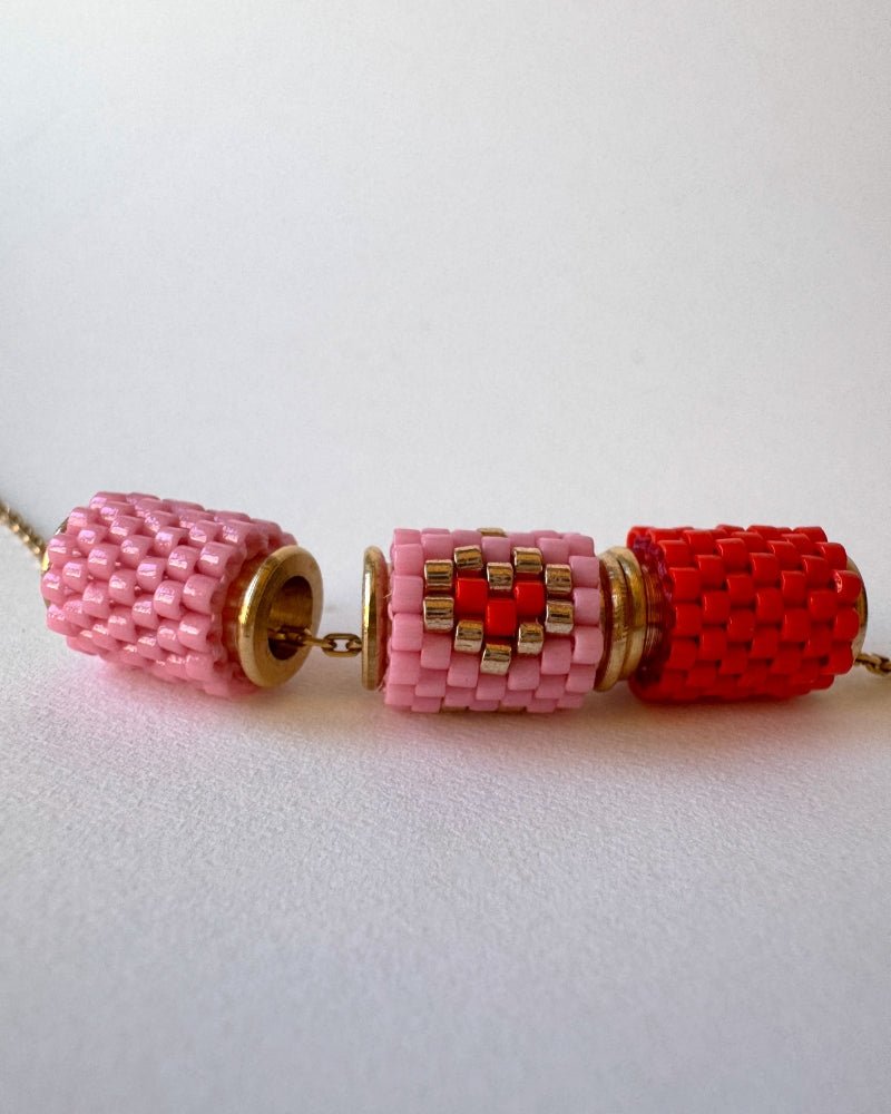 Necklace with three beaded charms crafted in peyote stitch technique using Japanese Miyuki Delica beads in scarlet red and pink palette with heart motif - Fleur Du Jour